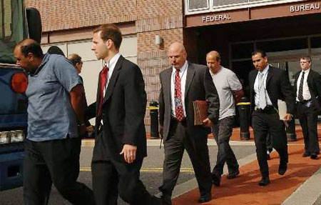 FBI agents escort unidentified suspects connected to a major corruption and international money laundering conspiracy probe to waiting buses July 23, 200,9 at the FBI's Newark, N.J., office